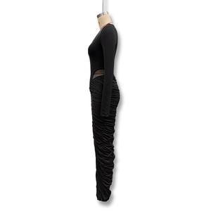 Detail of the side waist mesh cutout and ruching on the black bodycon dress