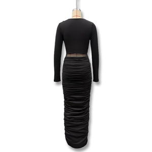 Detail of the elegant ruched texture on a black long sleeve bodycon maxi dress