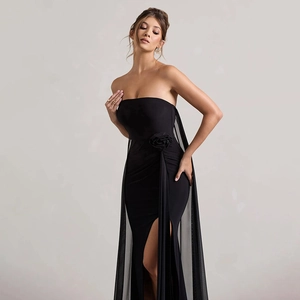 Detail of elegant black strapless gown featuring a fabric rose and sheer mesh ribbon