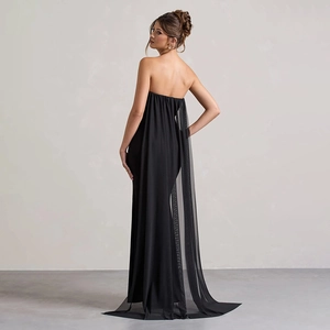 Rear view of black strapless evening gown featuring a lightweight flowing tulle cape detail