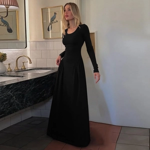 Detailed shot of a black slim fit long sleeve maxi dress featuring elegant u-neck design