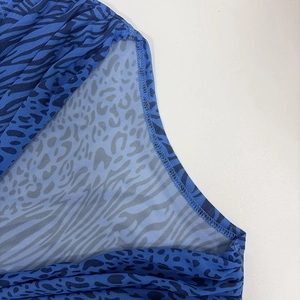 Detailed macro view of blue animal print mesh fabric with double-stitched reinforced edges