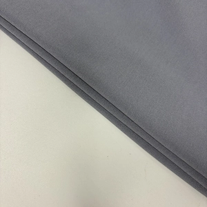 Macro detail of high-quality grey knitted fabric with delicate texture and drape