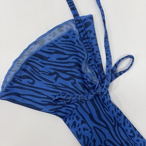 Detail shot of the blue leopard flocking mesh fabric with fine stitching and slim straps
