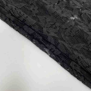 Close-up of black floral lace fabric featuring elegant sheer cutout textures and patterns
