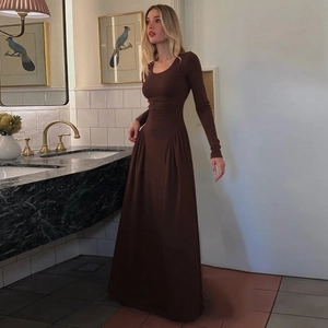 Detail of chocolate brown long sleeve maxi dress with elegant U-neck and waist pleats