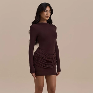 Detail view of ruched hemline and chocolate brown stretch fabric on slim fit dress