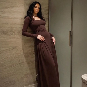 Close-up detail of the elegant coffee brown dress showing pleated long sleeve texture