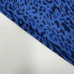 Detail of blue leopard print mesh fabric with flocking and breathable texture