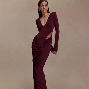 Detail of burgundy V-neck dress with side mesh cutouts and textured ruched fabric