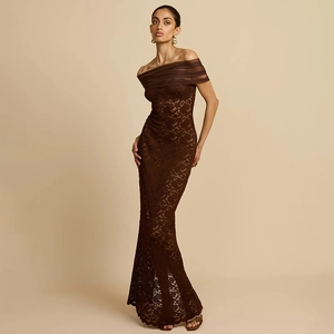 Detail of the off-shoulder neckline with brown lace and ruffled tulle on the dress