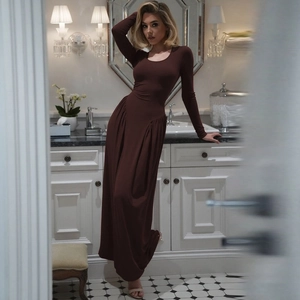 Detail of elegant dark brown long sleeve dress with waist pleats and tiered skirt