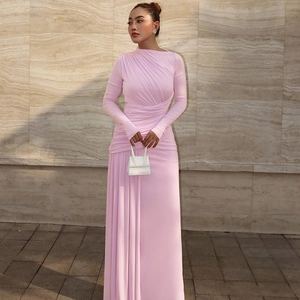 Detail showing elegant draped ruching and slim fit texture on a pink maxi dress