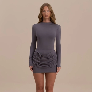 Detail view of ruched hem and textured fabric on long sleeve slim fit dress