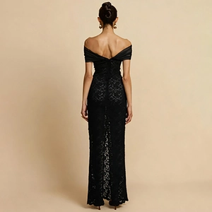 Detail view of the back of a black lace off-shoulder long dress with elegant slit design