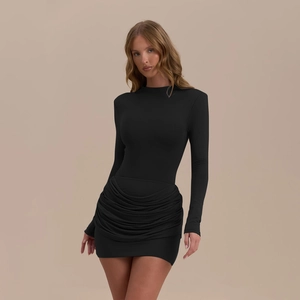 Detailed view of the ruched hemline and stretchy fabric on this black mini dress