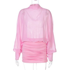 Detail of pink two-piece set featuring sheer mesh long sleeve top and ruched bodycon skirt