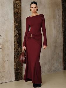 Close-up of side ruching and gold teardrop metal buckle on a burgundy maxi dress