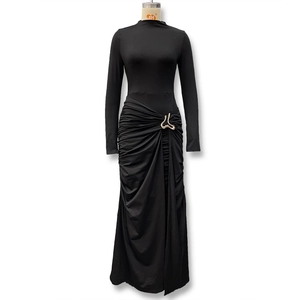 Close-up of black bodycon dress featuring elegant waist pleats and a gold metallic buckle