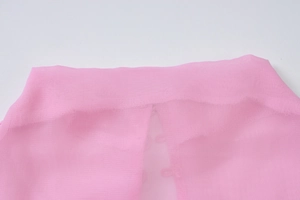 Close-up detail of sheer pink chiffon fabric showing delicate texture and fine stitching