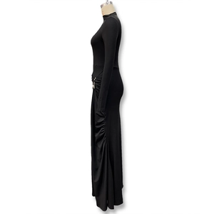 Close-up of ruched waist detail with metal buckle on black long sleeve slim dress