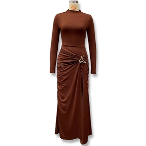 Detail of waist ruffles and silver buckle on caramel long sleeve bodycon dress