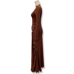 Detail of waist ruching with a silver metal buckle on a dark brown maxi dress