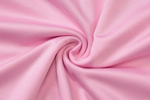 Close-up of pink pleated chiffon fabric showing detailed knit texture and soft drape