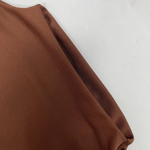 Close-up of brown ribbed knit fabric showing detailed stitching and elastic texture