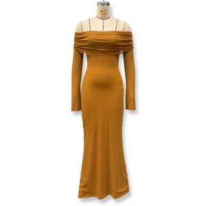 Detail of off-shoulder mustard yellow gown featuring ruffled layers and glittery mesh fabric
