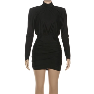 Detail of ruched hips and shoulder pads on a black bodycon turtleneck mini dress
