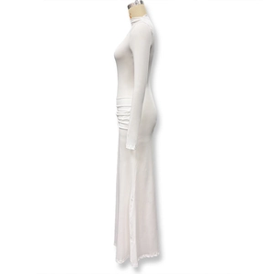 Close-up of elegant side pleats and ruched details on white long sleeve maxi dress