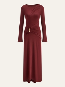 Detail view of wine red dress with elegant waist pleats and golden teardrop metal buckle