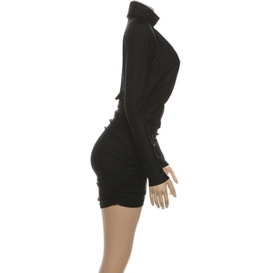 Close-up of side ruching on a black turtleneck long sleeve bodycon mini dress