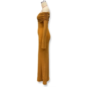 Detail of ginger yellow off-shoulder maxi dress with sparkling mesh fabric and ruched sleeves
