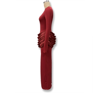 Détail d'une robe maxi bordeaux avec volants superposés et coupe moulante élégante