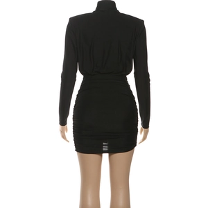 Close-up of the back view of a black ruched mini dress with a high collar and long sleeves