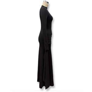 Detail view of ruched fabric and side pleats on an elegant black long sleeve maxi dress