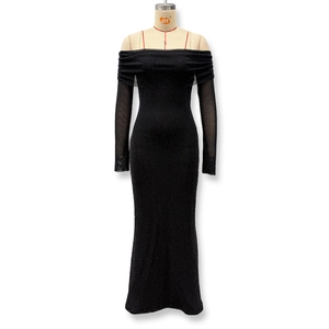 Detail of shimmering silver sequins on an off-shoulder black evening gown with mesh sleeves