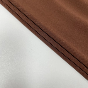 Macro close-up showing the brown knitted fabric texture and fine vertical ribbing details