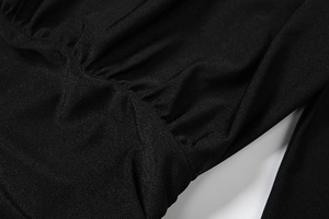 Macro shot of high-quality black ruched fabric texture with fine stitching on dress