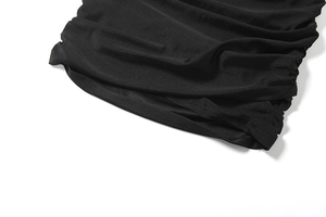 Close-up of black high neck dress featuring premium elastic ruched fabric and texture