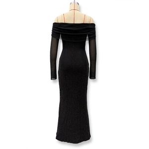 Close-up of sparkling black fabric and sheer mesh sleeves on the off-shoulder dress