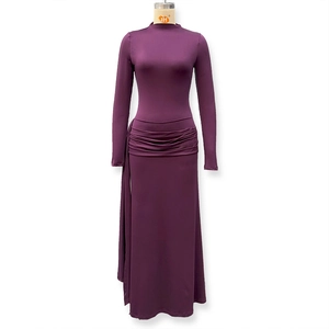 Detail view of the elegant deep purple long sleeve dress showing side ruching and draping