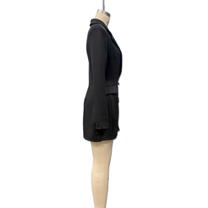 Detail of black long sleeve blazer dress featuring side lapels and pocket flaps