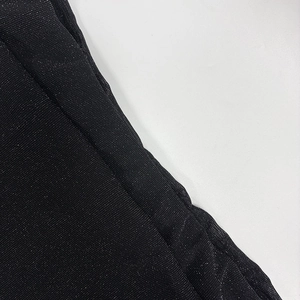 Macro shot of the black shimmering mesh fabric with silver glitter finish for dress detail