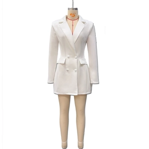 Detailed view of the double-breasted buttons and flap pockets on white blazer dress