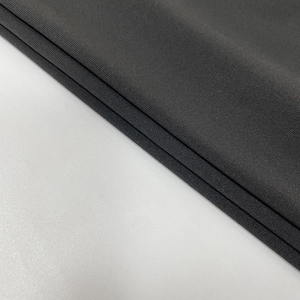 Close-up of high-density dark grey knit fabric with premium matte texture and elasticity
