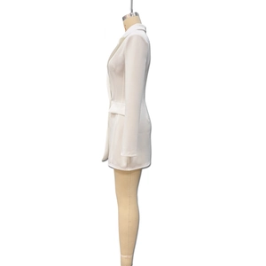 Side view of white fitted blazer dress featuring long sleeves and notched lapels
