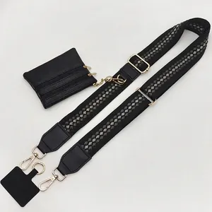 Adjustable black crossbody strap with diamond pattern, coin purse, and gold hardware